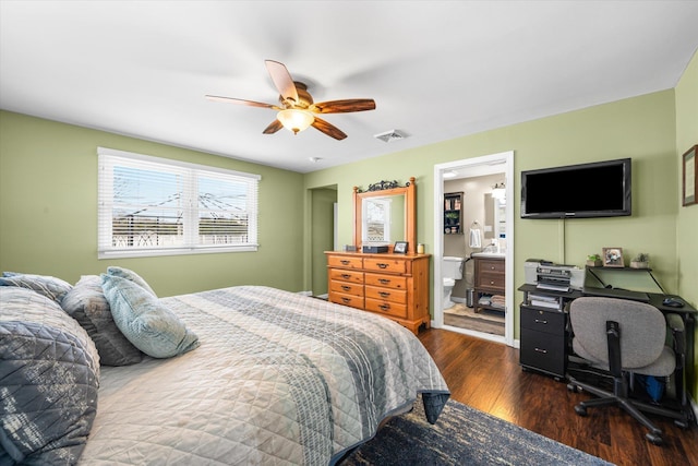 bedroom featuring dark hardwood / wood-style floors, ceiling fan, and connected bathroom