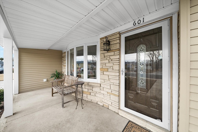 view of exterior entry with covered porch