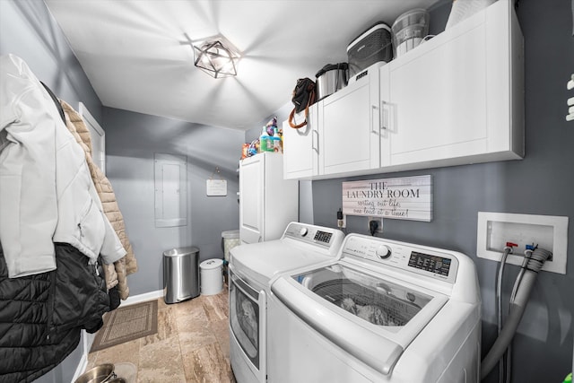 laundry area featuring separate washer and dryer and cabinets