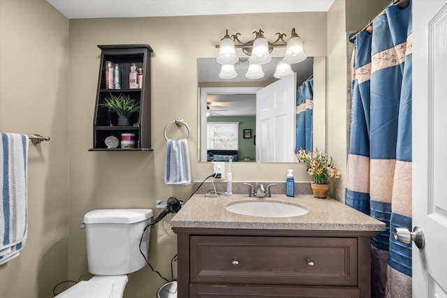 bathroom with vanity, ceiling fan, and toilet