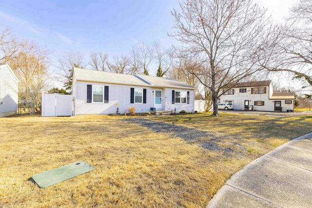 ranch-style home featuring a front yard and fence