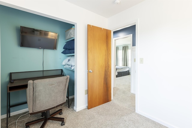 carpeted office featuring baseboards