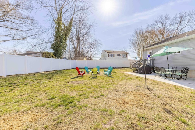 view of yard featuring a patio area, a fenced backyard, and an outdoor fire pit