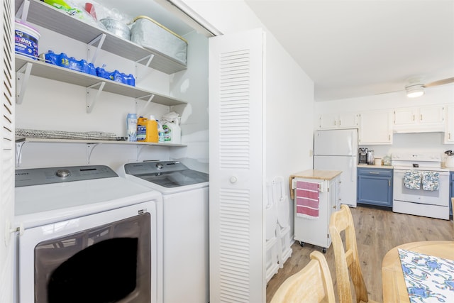 laundry room featuring laundry area, washer and dryer, and light wood-style floors