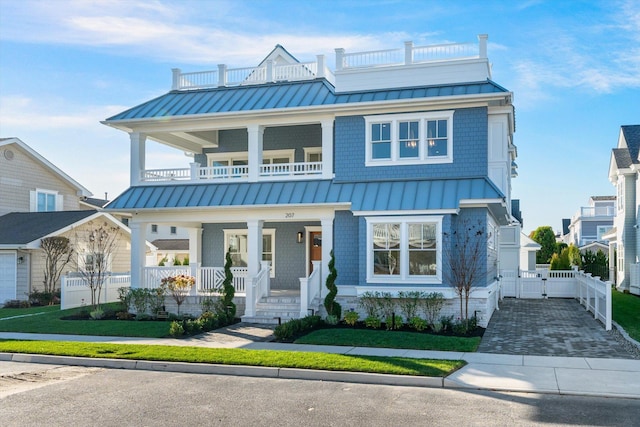 view of front of property featuring covered porch and a balcony