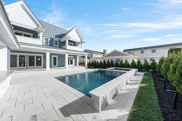 view of pool featuring an in ground hot tub and a patio