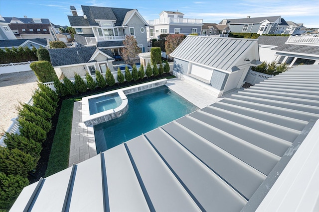 view of swimming pool with an in ground hot tub