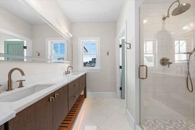 bathroom featuring tile patterned floors, vanity, and a shower with door