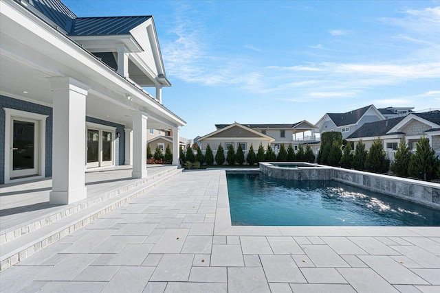 view of pool with an in ground hot tub and a patio area