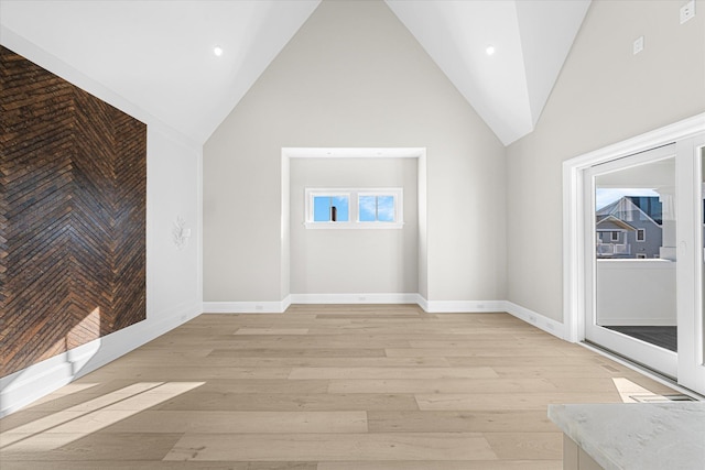 bonus room with high vaulted ceiling and light hardwood / wood-style flooring