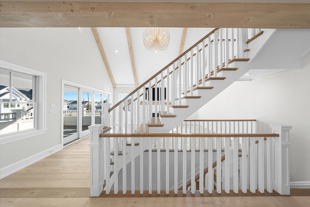 stairs featuring beam ceiling, high vaulted ceiling, an inviting chandelier, and wood-type flooring