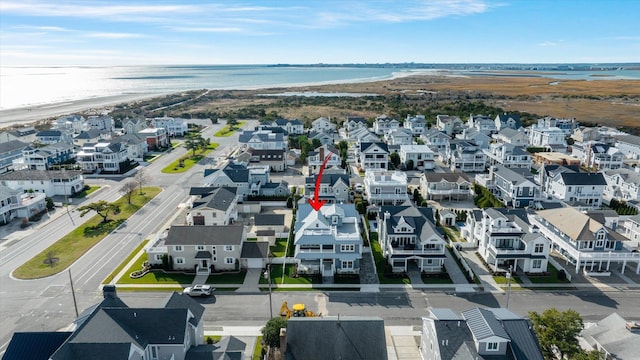 birds eye view of property with a water view and a view of the beach