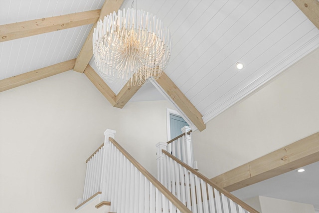 stairs featuring lofted ceiling with beams and a chandelier