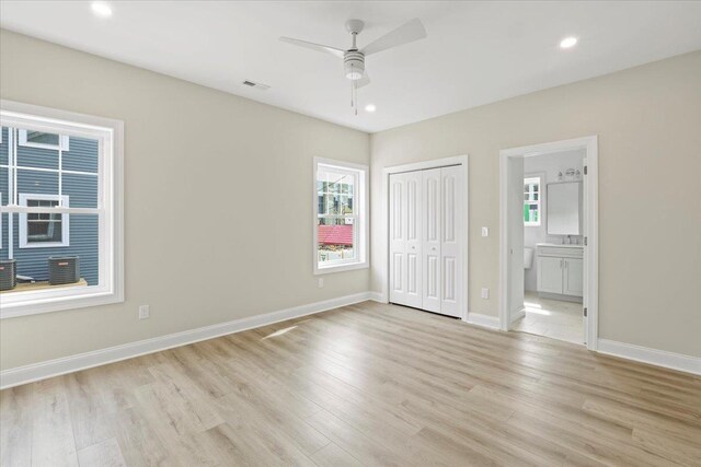 165 E Garfield Ave Unit 110, Wildwood, NJ 08260 - unfurnished bedroom featuring light wood-type flooring, multiple windows, connected bathroom, recessed lighting, and a closet