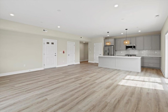 165 E Garfield Ave Unit 110, Wildwood, NJ 08260 - unfurnished living room with light wood-style flooring and recessed lighting