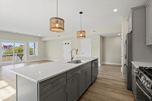 165 E Garfield Ave Unit 110, Wildwood, NJ 08260 - kitchen with gray cabinetry, stainless steel appliances, light countertops, light wood finished floors, and recessed lighting