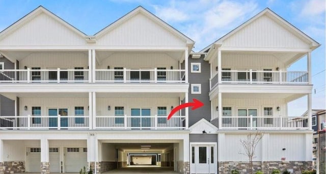 165 E Garfield Ave Unit 110, Wildwood, NJ 08260 - townhome / multi-family property featuring a carport, a balcony, driveway, and a garage