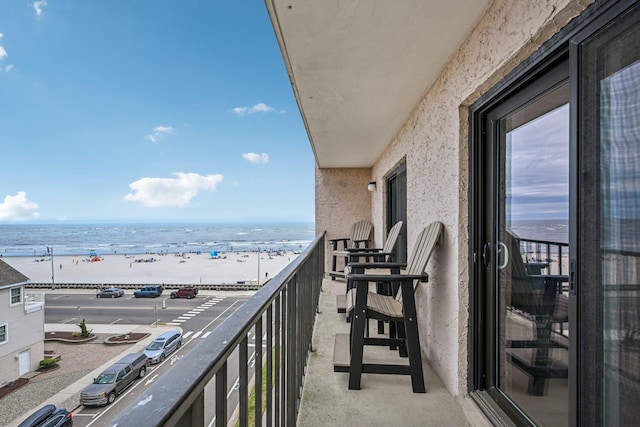 balcony with a view of the beach and a water view