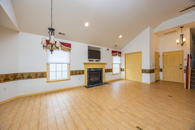 5011 Haven Ave Unit 2, Ocean City, NJ 08226 - unfurnished living room featuring a chandelier, high vaulted ceiling, plenty of natural light, a fireplace, and light wood-style floors