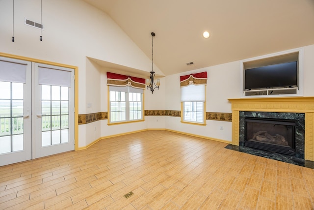 5011 Haven Ave Unit 2, Ocean City, NJ 08226 - unfurnished living room featuring a fireplace, wood finished floors, french doors, high vaulted ceiling, and baseboards