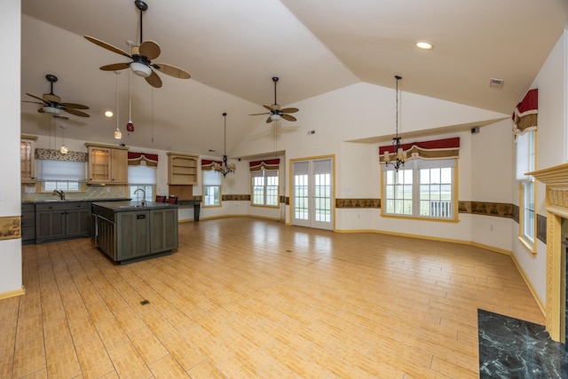 5011 Haven Ave Unit 2, Ocean City, NJ 08226 - kitchen featuring dark countertops, a ceiling fan, light wood finished floors, tasteful backsplash, and a kitchen island with sink