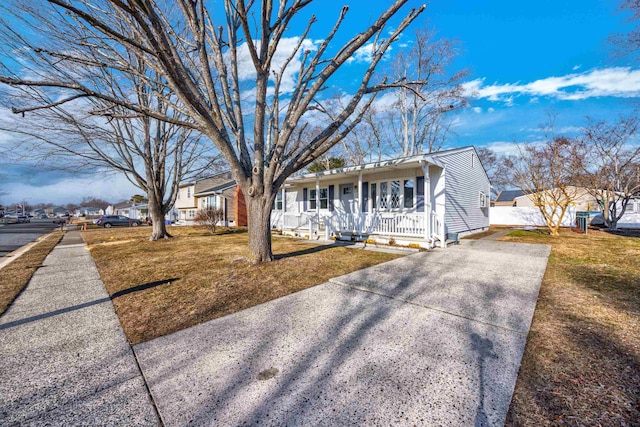 ranch-style house with a front yard and a porch