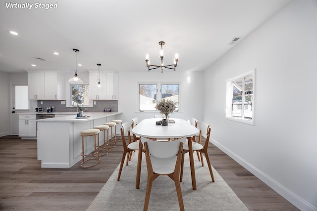 dining room featuring hardwood / wood-style floors and a notable chandelier