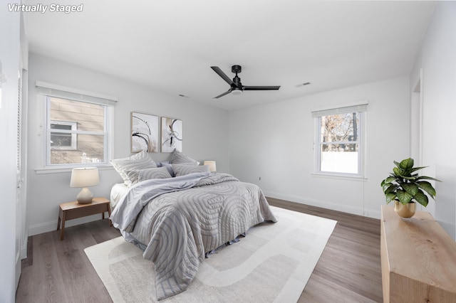 bedroom featuring ceiling fan and dark hardwood / wood-style floors