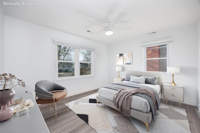 bedroom with hardwood / wood-style flooring and ceiling fan