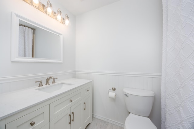 bathroom featuring vanity and toilet