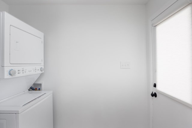 clothes washing area with stacked washer and dryer