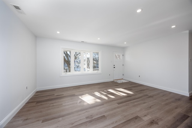 spare room with wood-type flooring