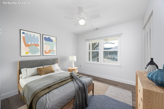 bedroom featuring hardwood / wood-style flooring, a closet, and ceiling fan