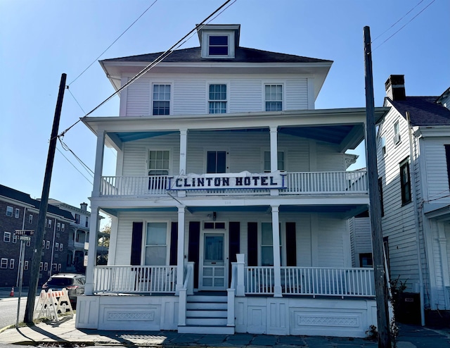 view of front of property featuring a porch and a balcony