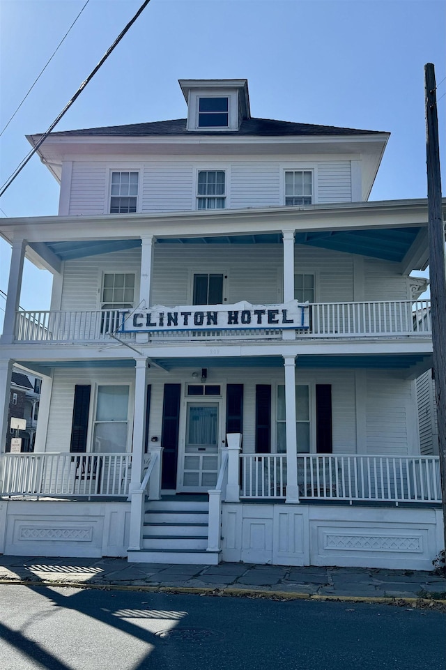 view of front of home with a porch and a balcony