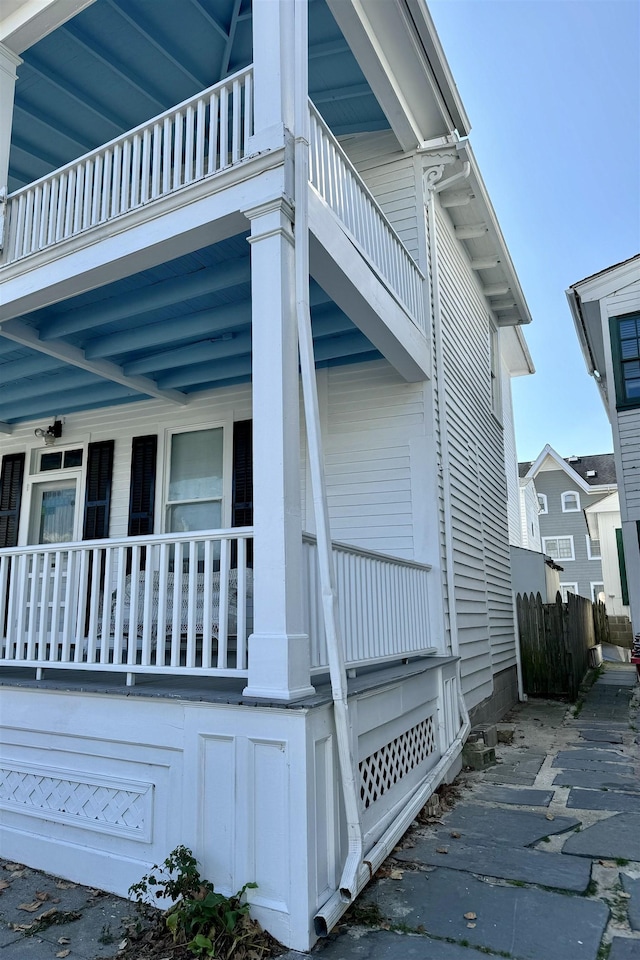 view of side of home with covered porch