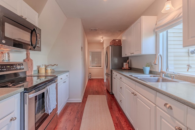 15 Seaview Ave, Beesleys Point, NJ 08223 - kitchen with appliances with stainless steel finishes, dark wood-style flooring, white cabinetry, and light countertops