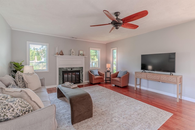 15 Seaview Ave, Beesleys Point, NJ 08223 - living room featuring a fireplace, wood finished floors, and a ceiling fan