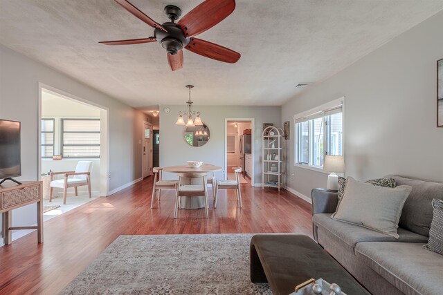 15 Seaview Ave, Beesleys Point, NJ 08223 - living room with wood finished floors, a ceiling fan, and a chandelier