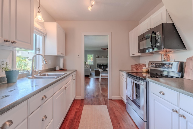 15 Seaview Ave, Beesleys Point, NJ 08223 - kitchen with electric stove, black microwave, wood finished floors, and white cabinetry