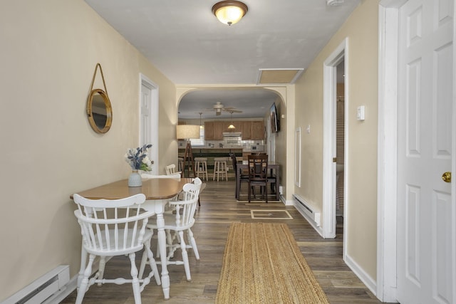 39 E Pacific Ave, Villas, NJ 08251 - dining space featuring a baseboard heating unit, a baseboard radiator, dark wood-style flooring, a ceiling fan, and arched walkways