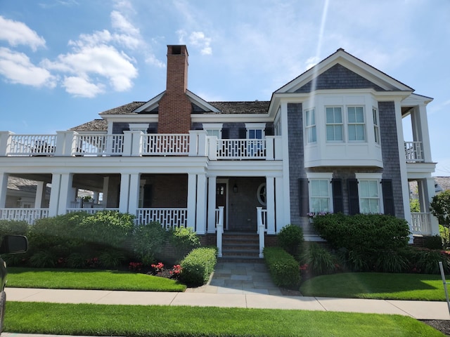 8700 1st Ave, Stone Harbor, NJ 08247 - view of front facade featuring a balcony, a chimney, and a porch
