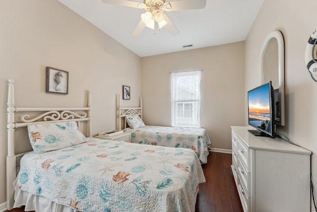 bedroom featuring a ceiling fan, visible vents, dark wood-style flooring, and baseboards