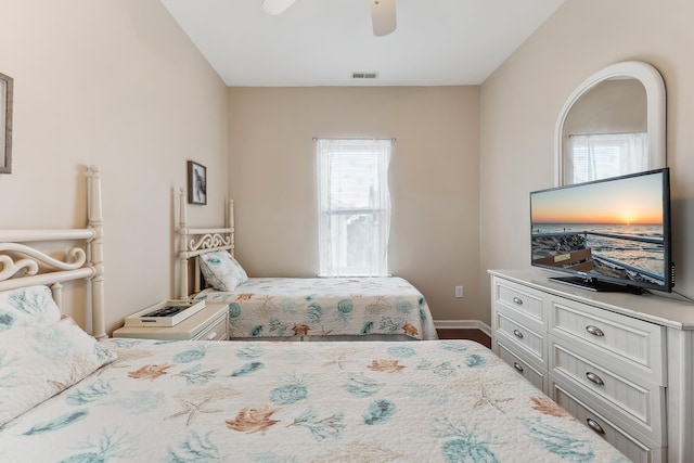 bedroom featuring a ceiling fan, visible vents, and baseboards