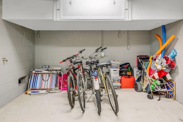 interior space featuring concrete block wall and bike storage