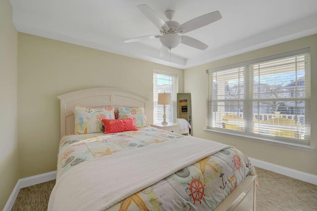 bedroom with baseboards, a ceiling fan, and light colored carpet