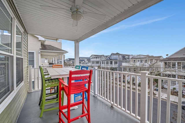 balcony with ceiling fan and a residential view