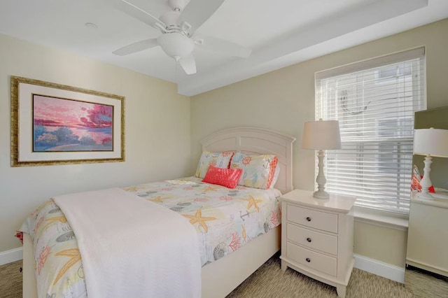 bedroom with a ceiling fan and baseboards