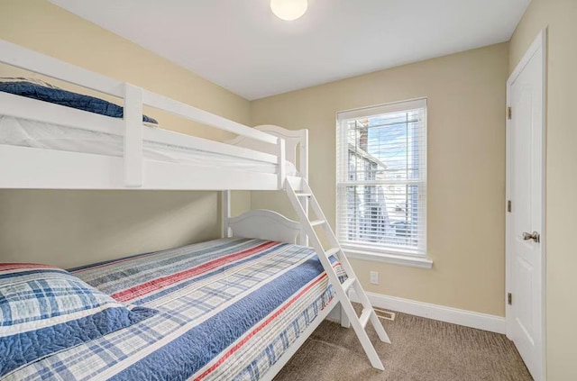 carpeted bedroom featuring baseboards