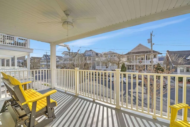 exterior space featuring ceiling fan and a residential view